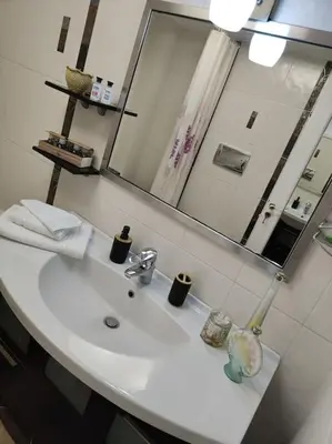 a bathroom with a sink and a mirror at Lefkothea's house in Athens