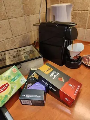 a counter top with books and a coffee maker at Lefkothea's house in Athens