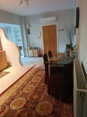 a living room with a table and a dining room at Lefkothea's house in Athens