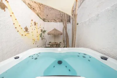 a bath tub in a room with a table at Kastela's Harbor Retreat with Jacuzzi in Piraeus