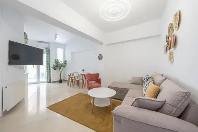 a living room with a couch and a table at Kastela's Harbor Retreat with Jacuzzi in Piraeus