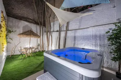 a bathtub in a room with a table and a table at Kastela's Harbor Retreat with Jacuzzi in Piraeus