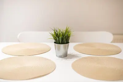 a table with four plates and a potted plant at Sea Breeze Suite with Jacuzzi in Piraeus