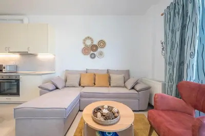 a living room with a couch and a table at Sea Breeze Suite with Jacuzzi in Piraeus