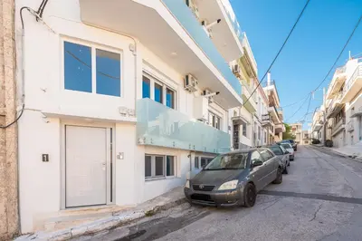 a car parked next to a building on a street at Sea Breeze Suite with Jacuzzi in Piraeus