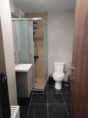 a bathroom with a toilet and a sink and a shower at CozyStation in Athens