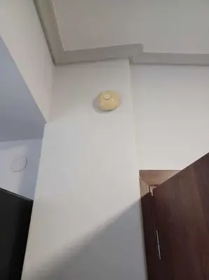 a room with a ceiling with a light on the wall at CozyStation in Athens