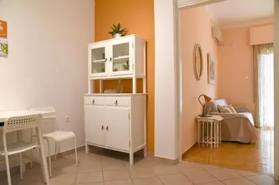 a room with a white cabinet and a table at Elektras Akropolis Apartment in Athens