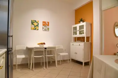 a dining room with a white table and chairs at Elektras Akropolis Apartment in Athens