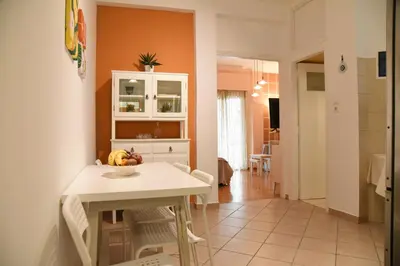 a kitchen with a table with a bowl of fruit on it at Elektras Akropolis Apartment in Athens