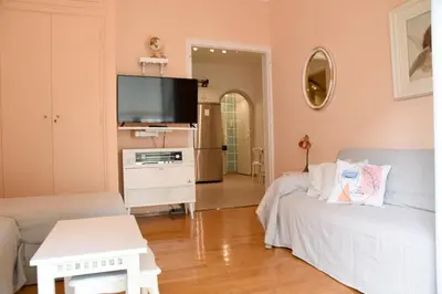 a living room with a couch and a flat screen tv at Elektras Akropolis Apartment in Athens
