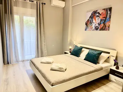 a bedroom with a bed with a painting on the wall at Victoria Secret Suite greendom in Athens