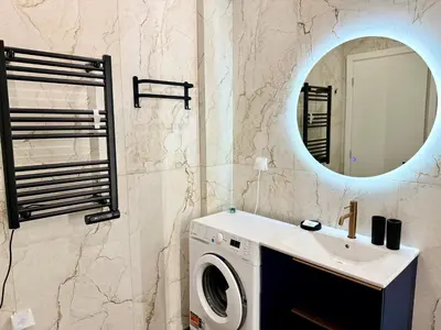 a bathroom with a washing machine and a sink at Victoria Secret Suite greendom in Athens