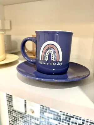 a blue coffee cup sitting on a shelf at Victoria Secret Suite greendom in Athens