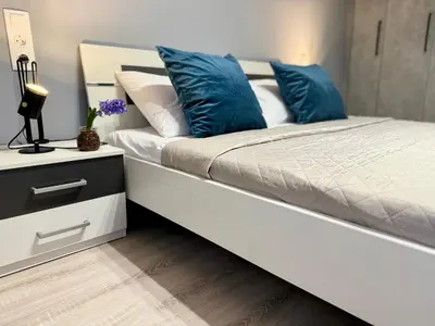 a bedroom with a bed with blue pillows on it at Victoria Secret Suite greendom in Athens