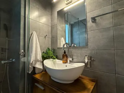 a bathroom with a white sink and a mirror at EMERALD LAKE RESIDENCE in Athens
