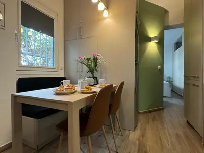 a kitchen with a table with plates of food on it at EMERALD LAKE RESIDENCE in Athens