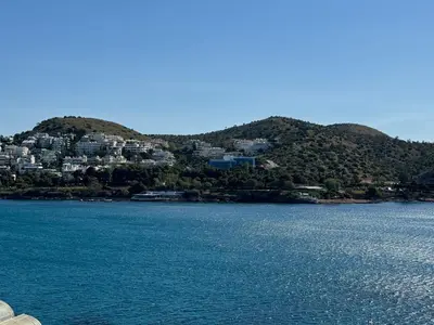 a large body of water with houses on a hill at EMERALD LAKE RESIDENCE in Athens