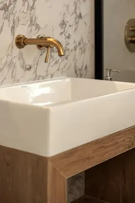 a white bathroom sink with a gold faucet at Victoria Luxury Suite - Private Jacuzzi & Terrace in Athens