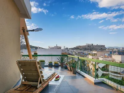 a balcony with a chair and a view of a city at Acropolis Music Studio Loft in Athens