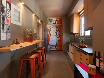 a kitchen with a counter and stools in a room at Acropolis Music Studio Loft in Athens