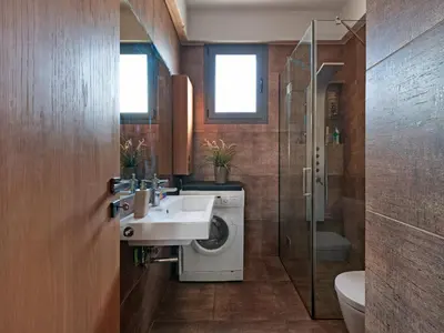a bathroom with a washing machine and a sink at Acropolis Music Studio Loft in Athens