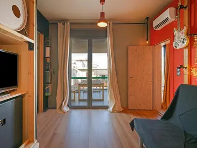 a living room with a television and a sliding glass door at Acropolis Music Studio Loft in Athens