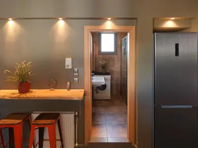 a kitchen with a counter and a sink and a refrigerator at Acropolis Music Studio Loft in Athens