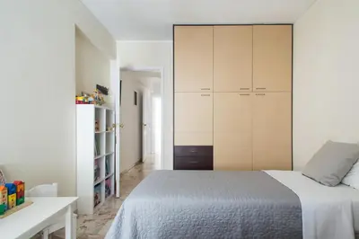 a bedroom with a bed and a large closet at Faliro Riviera Seaview flat in Athens