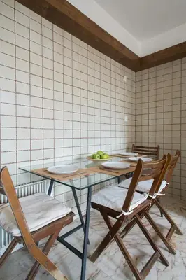 a table and chairs in a room with a wall at Faliro Riviera Seaview flat in Athens