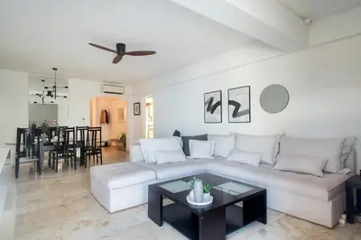 a living room with a white couch and a table at Faliro Riviera Seaview flat in Athens