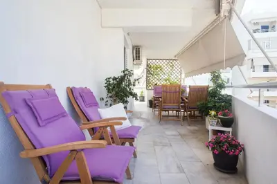 a group of purple chairs sitting on a balcony at Faliro Riviera Seaview flat in Athens