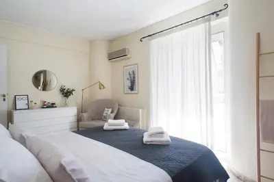 a bedroom with a large bed with towels on it at Faliro Riviera Seaview flat in Athens