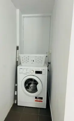 a washer and dryer in a small room at Comfortable and Bright 2bdr flat in Athens
