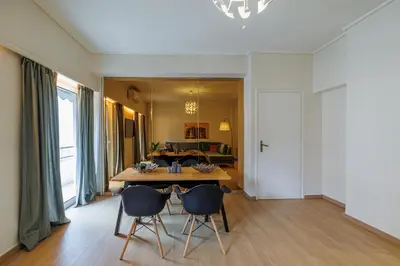 a dining room with a table and chairs at Comfortable and Bright 2bdr flat in Athens