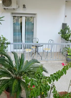a balcony with a table and chairs and plants at Dream apartment in Kallithea in Athens