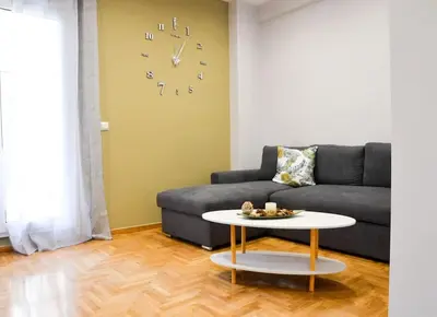 a living room with a couch and a table at Dream apartment in Kallithea in Athens