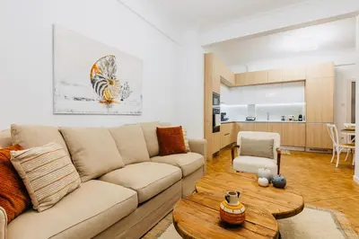 a living room with a couch and a table at Hidden Treasure of Koukaki in Athens