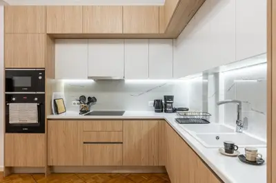 a kitchen with white cabinets and a sink at Hidden Treasure of Koukaki in Athens