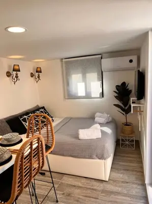 a bedroom with a bed and a table and chairs at Athena 2 in Athens
