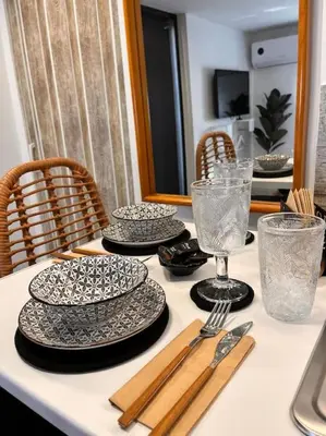 a table with plates and glasses and utensils on it at Athena 2 in Athens