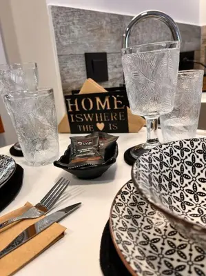 a table with plates and glasses on a table at Athena 2 in Athens