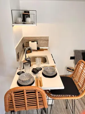 a kitchen with a table with chairs and a sink at Athena 2 in Athens