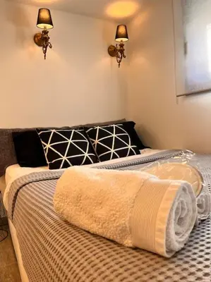 a bedroom with a bed with a towel on it at Athena 2 in Athens