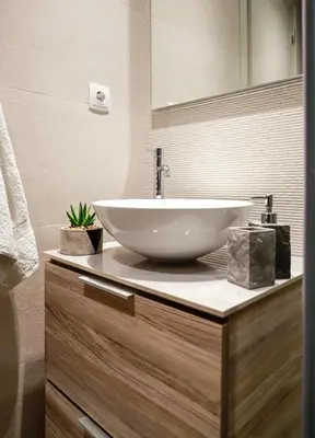a bathroom with a white bowl sink on a counter at Cutie Studio Apartment in Koukaki in Athens