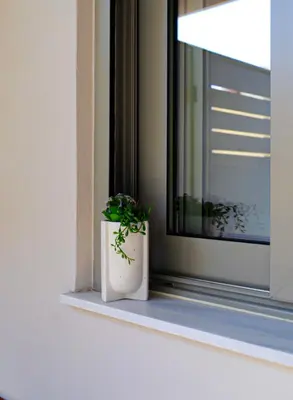 a potted plant sitting on a window sill at Cutie Studio Apartment in Koukaki in Athens
