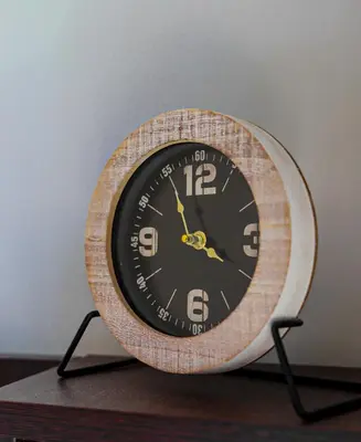 a clock sitting on top of a table at Cutie Studio Apartment in Koukaki in Athens
