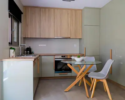 a small kitchen with a table and a counter top at Cutie Studio Apartment in Koukaki in Athens