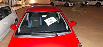 a red car with a sign taped to the back window at AIR-IN Rooms with magnificent views in Spáta