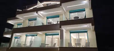 a building with tables and chairs on the balconies at AIR-IN Rooms with magnificent views in Spáta